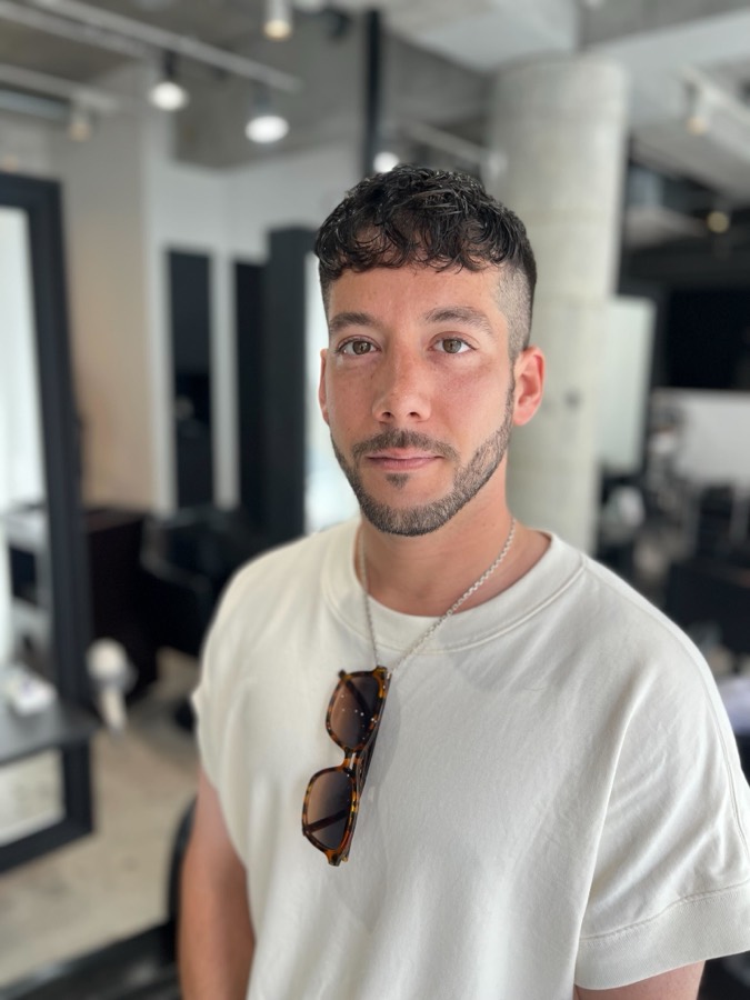 Curly hair, kept short and easy to style