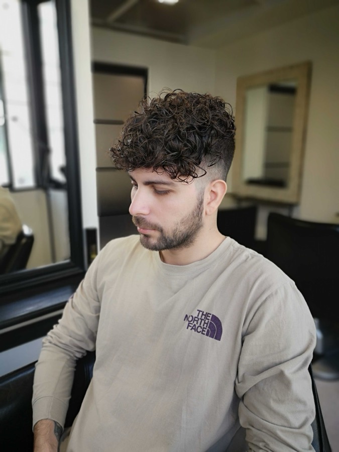 Curls left on top, tight around the sides