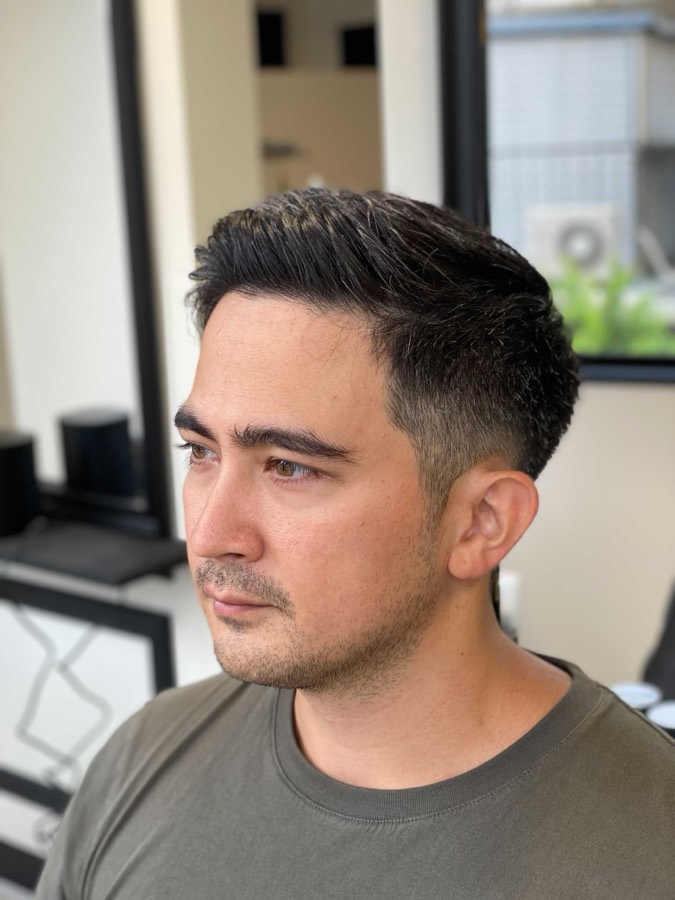 Swept back, tapered around the ears