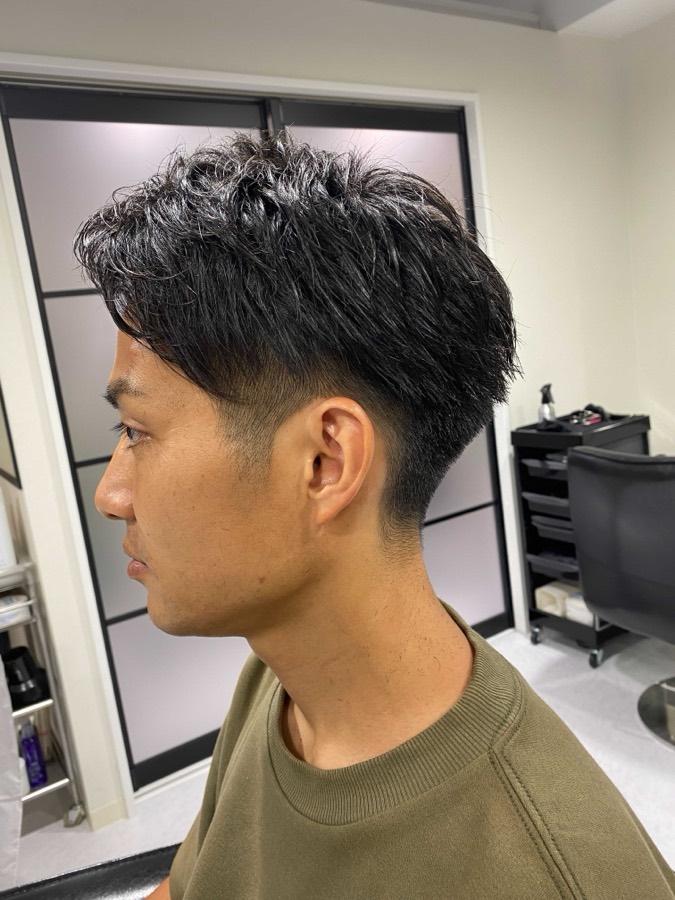 Thick straight hair, tapered at the neck