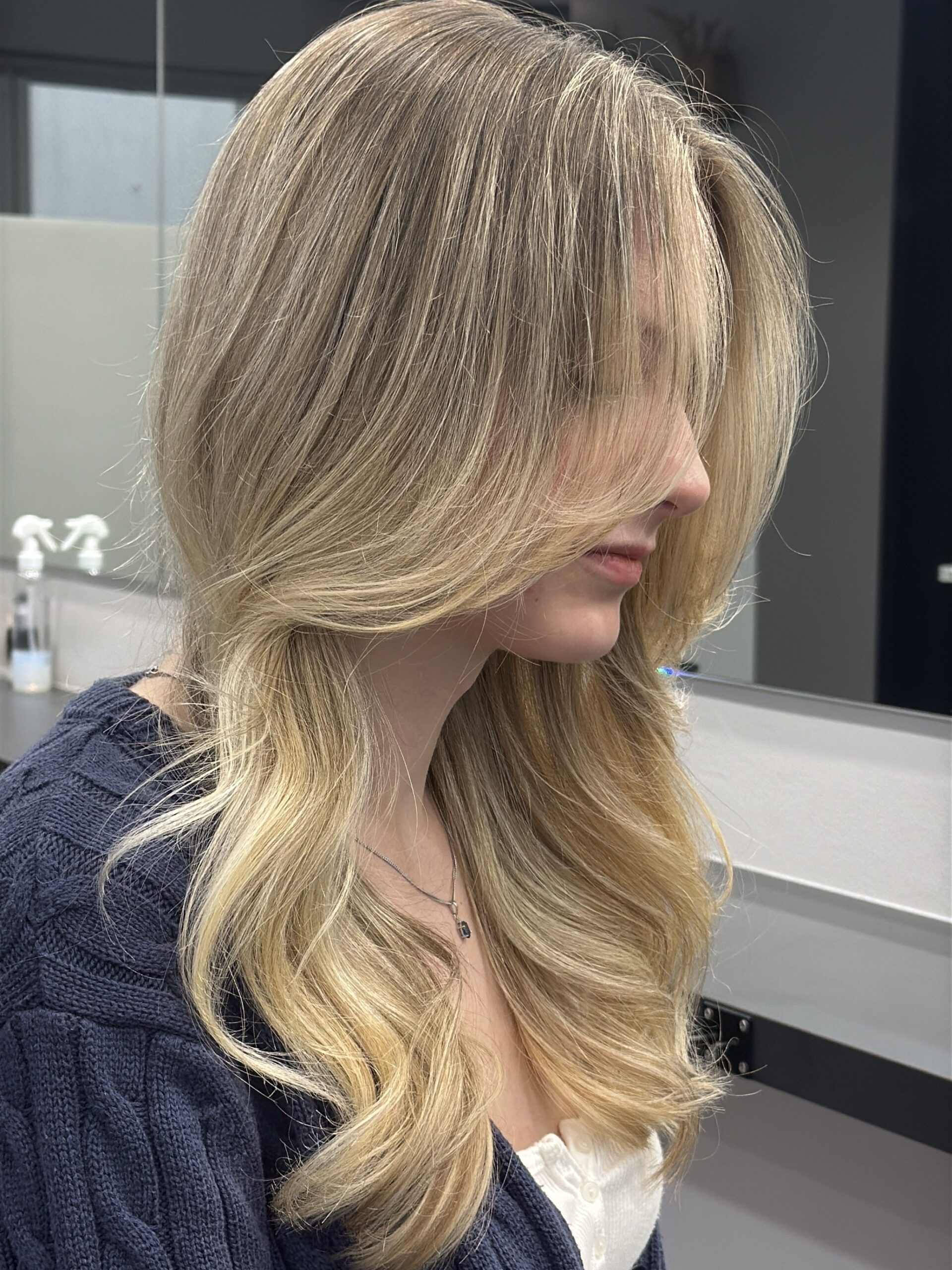 Dimensional hair color with soft highlights by a BORDERLESS SALON stylist